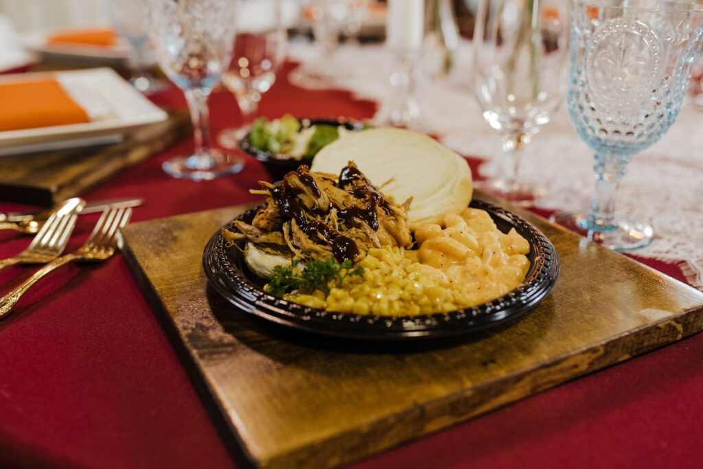 Black plastic plates and cutlery place setting from Nameless Catering