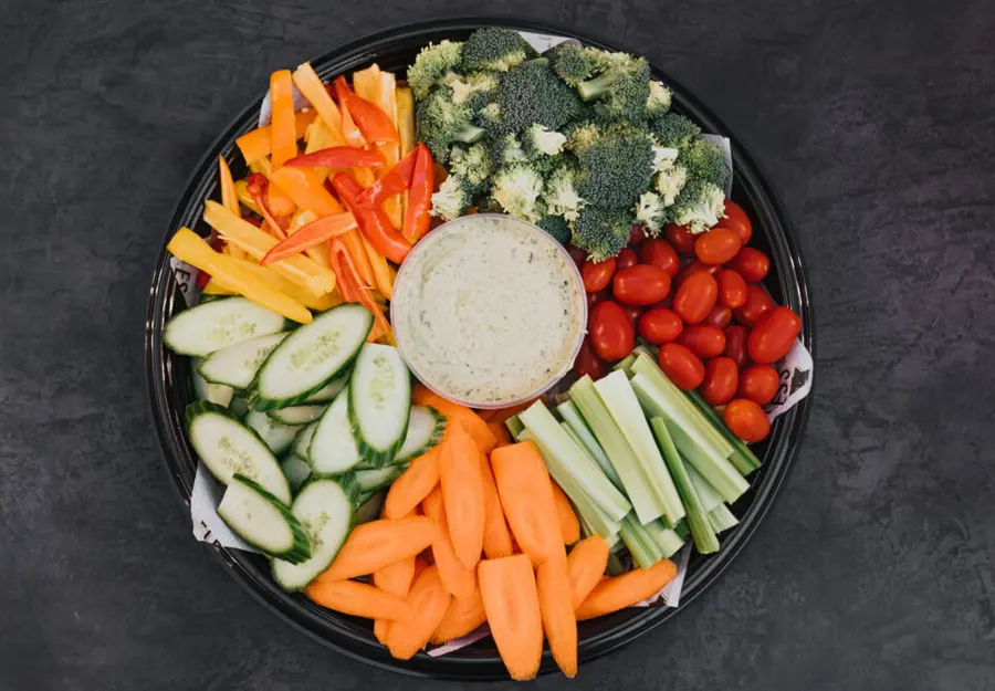 An overhead vegetable platter with dip for cocktail hour