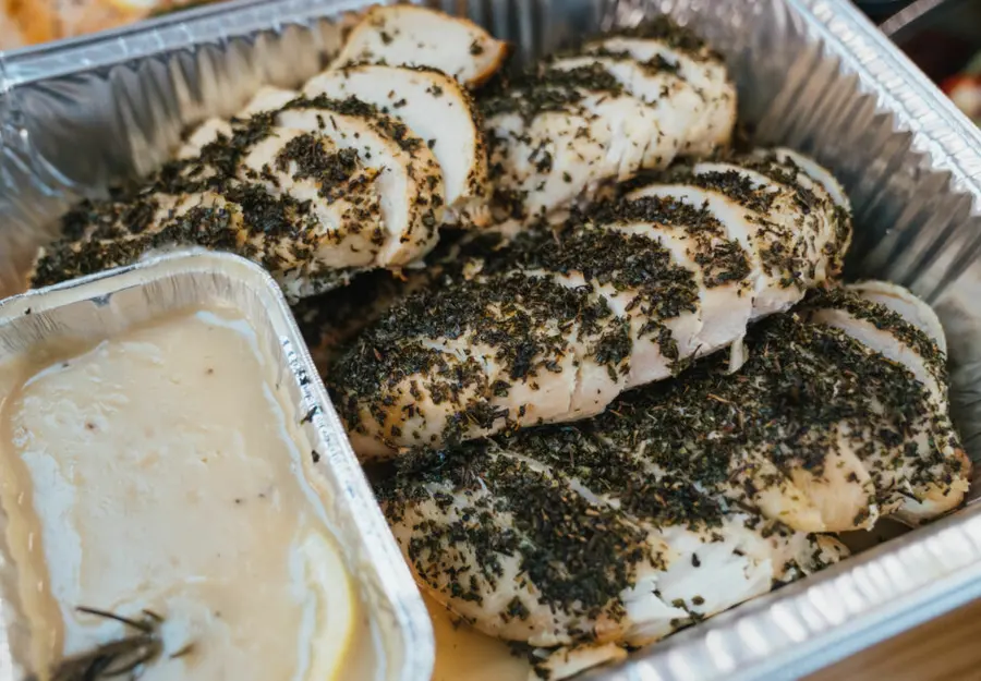 Herb roasted chicken breasts in a serving tray