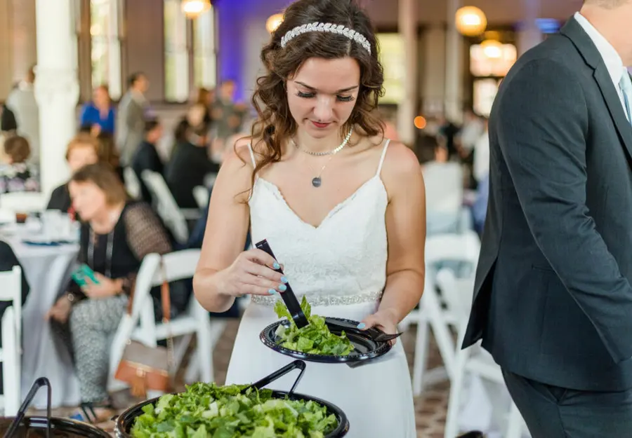 A bride serving herself at her wedding buffet